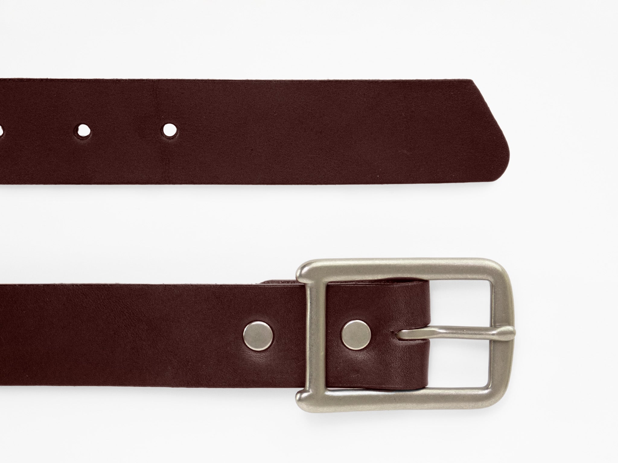A brown leather belt with a silver rectangular buckle, shown laid flat on a white background. The belt has several punched holes for adjusting the fit.