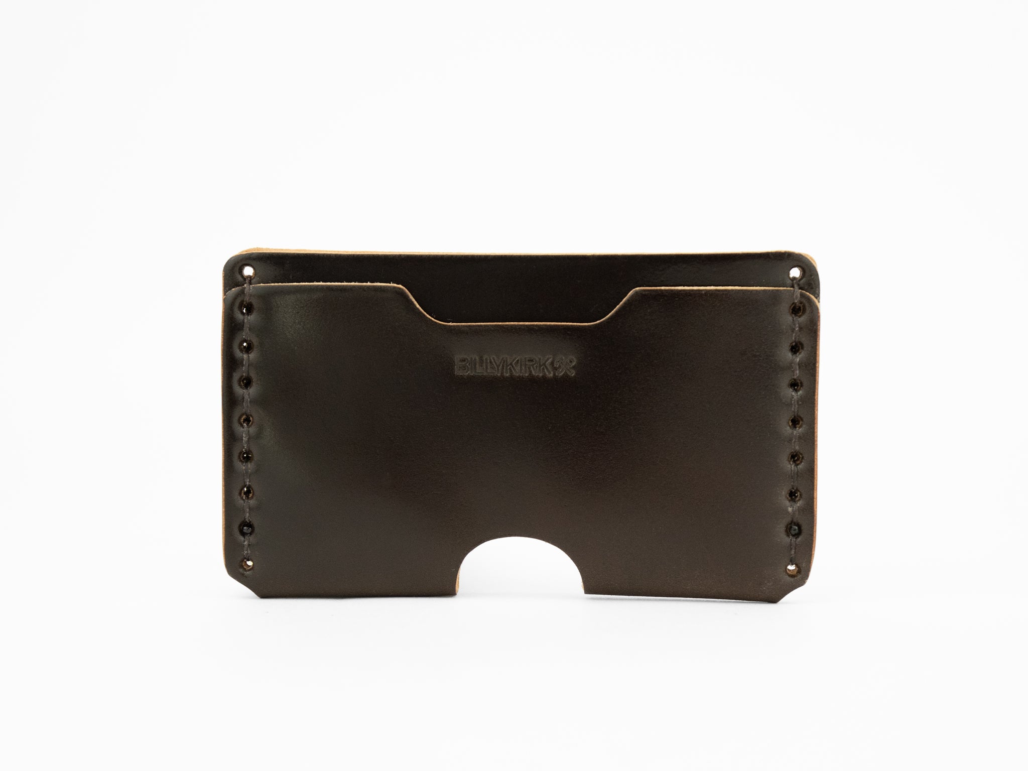 A dark brown cordovan leather wallet with visible stitching along the sides, an open slot on top, and a semicircular cutout at the bottom center. The word BILLYKIRK is embossed on the front.