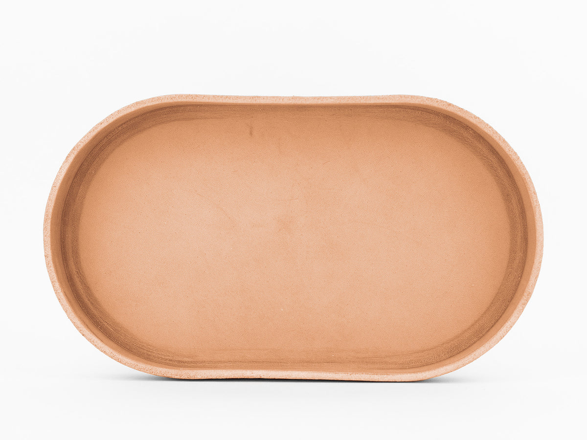 A plain, oval-shaped, natural colored  tray is shown from above against a white background.