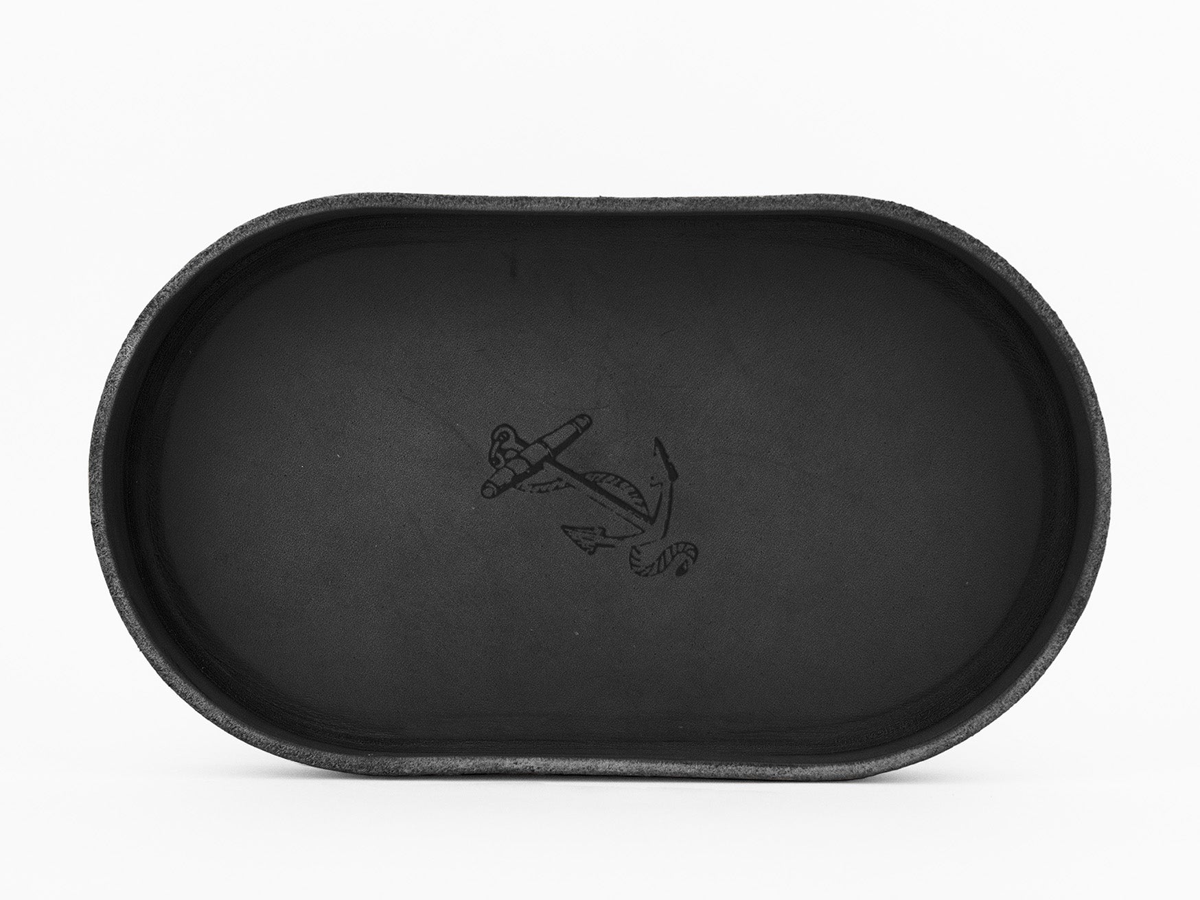 A black oval tray with a minimalist anchor and rope design engraved in the center, set against a white background.