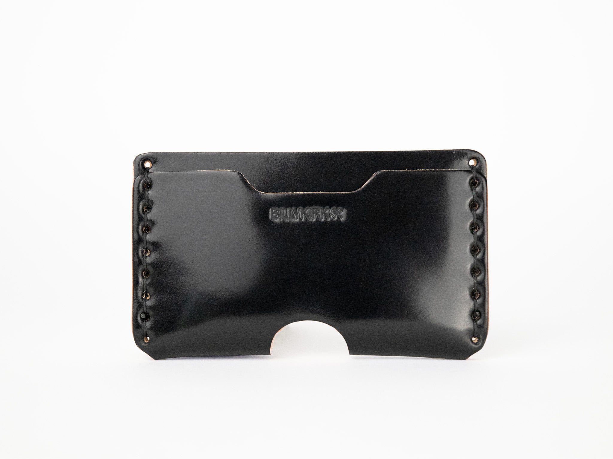 A black cordovan leather wallet with visible stitching along the sides, an open slot on top, and a semicircular cutout at the bottom center. The word BILLYKIRK is embossed on the front.