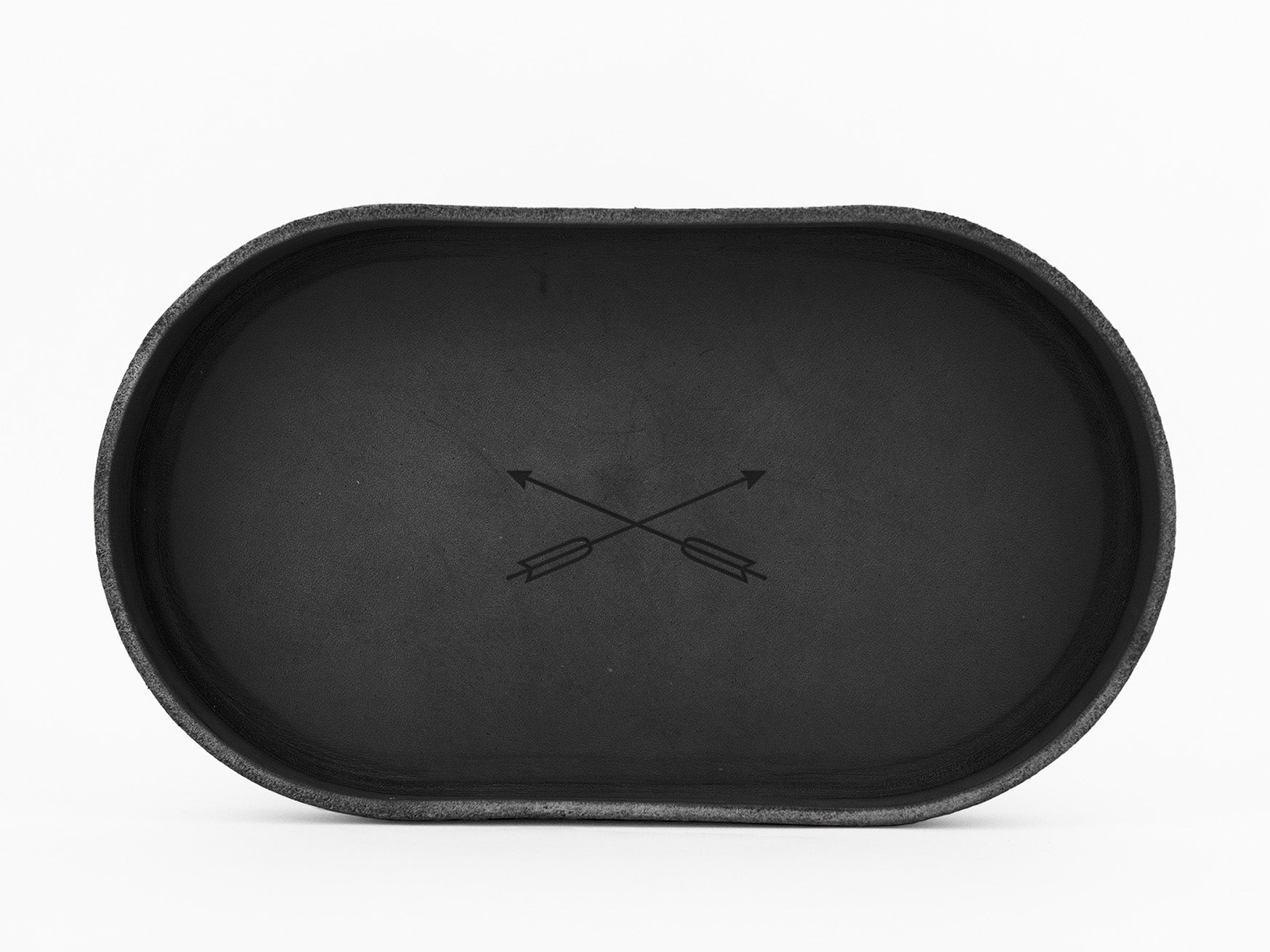 A black oval tray with a minimalist design featuring two crossed arrows in the center, placed on a white background.