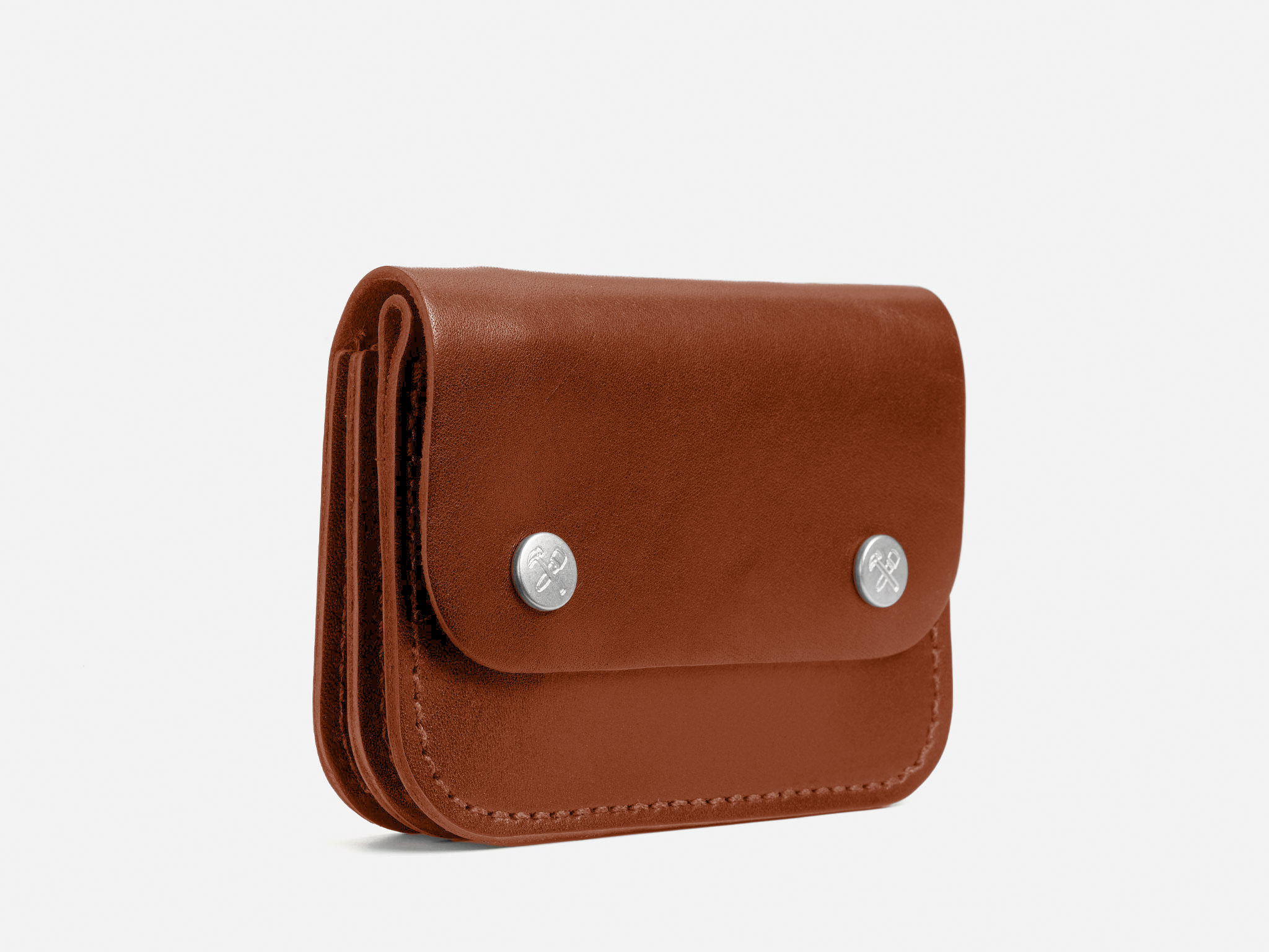 A brown leather wallet with rounded edges, two silver snap buttons on the front flap, and visible stitching along the sides, photographed against a white background.