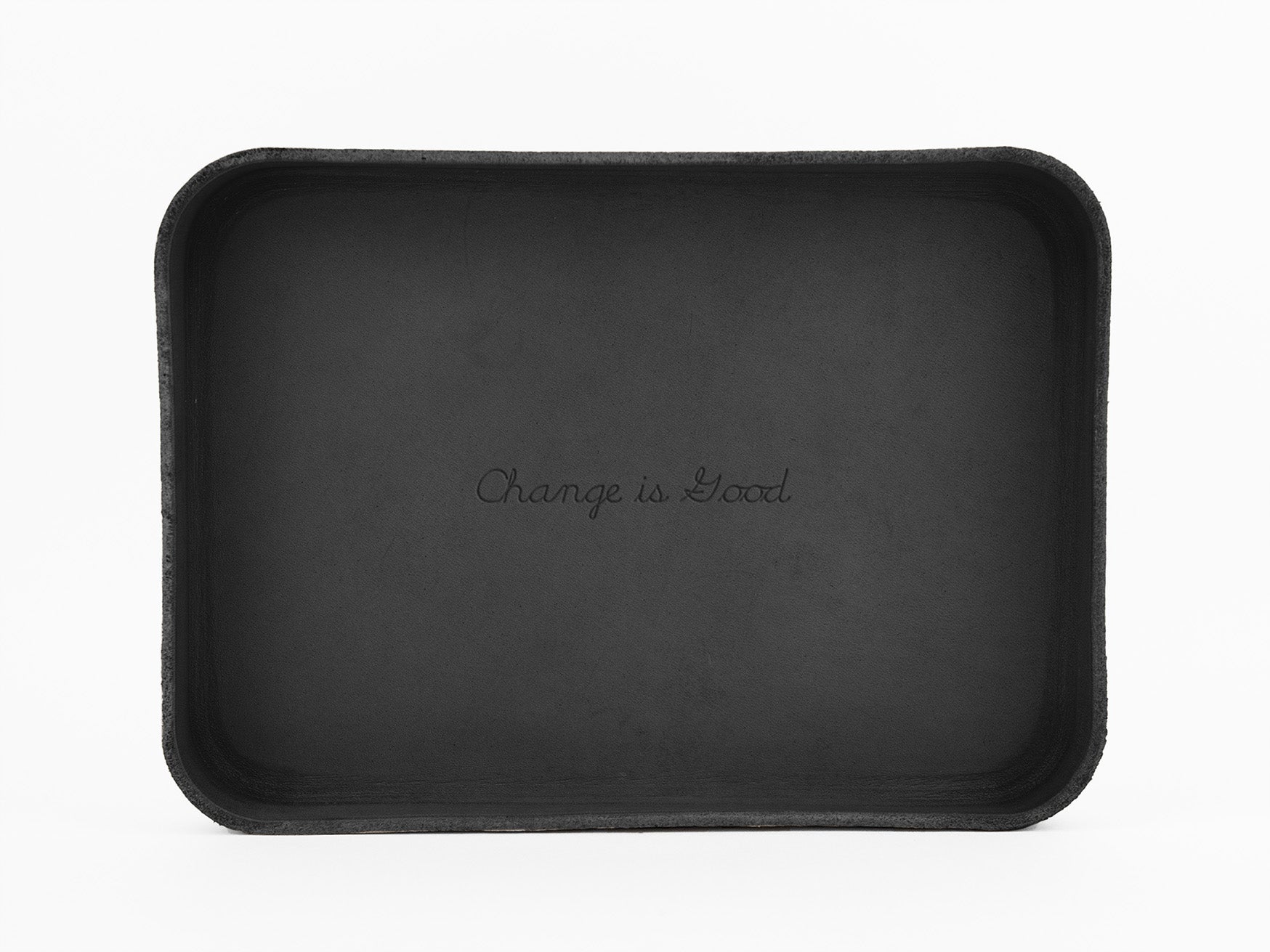 A black rectangular tray with the phrase Change is Good written in cursive in the center against a white background.