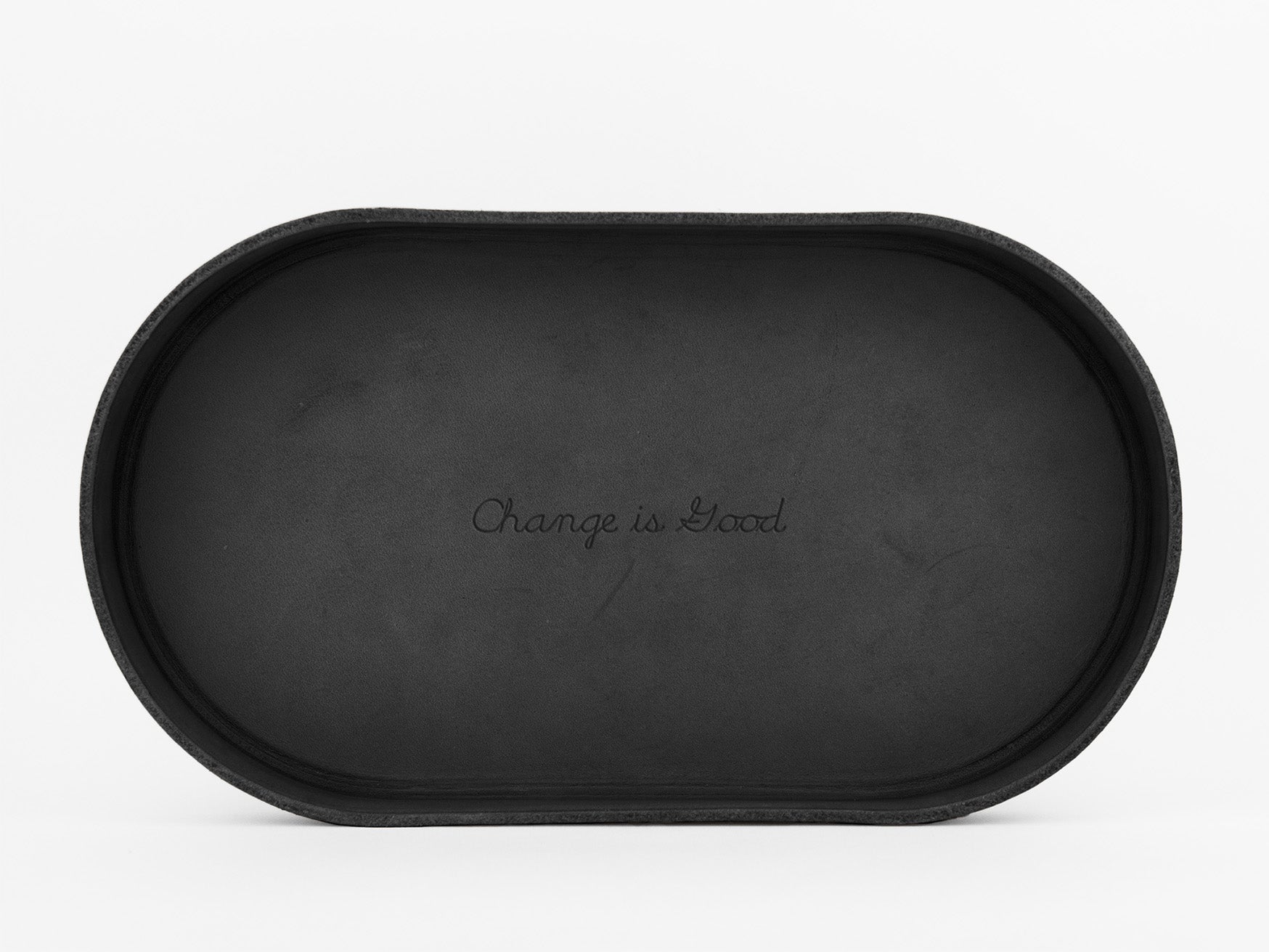 A black oval tray with the phrase Change is Good engraved in cursive at the center, set against a plain white background.