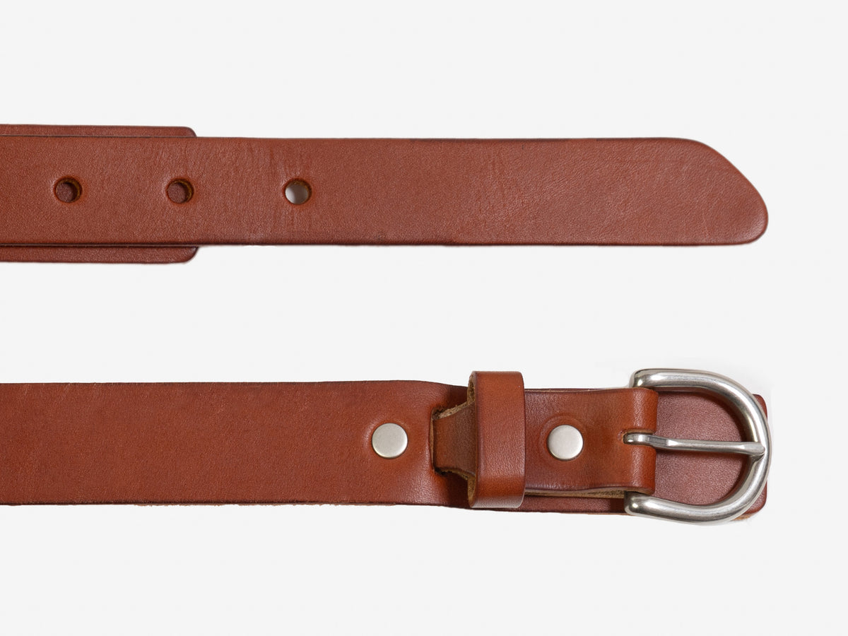 A brown leather belt with a silver buckle, shown laid flat. One section displays the pointed end with adjustment holes, while the other shows the buckle and loop detail.