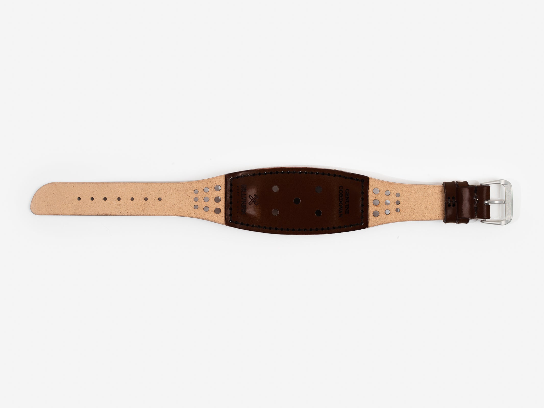 The back of the watch strap with natural and dark brown cordovan leather with holes, a silver buckle, and BILLYKIRK embossed on it.