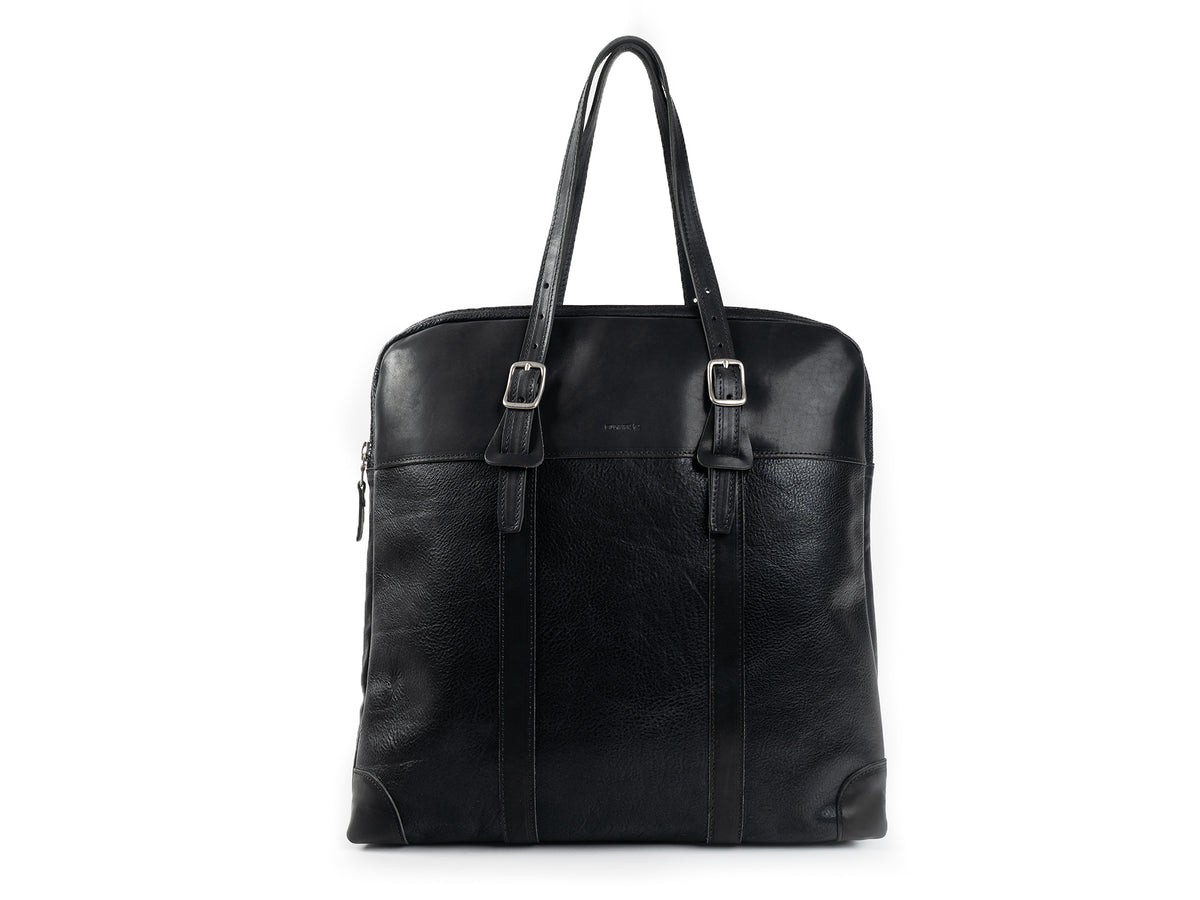 A black leather tote bag with two top handles, buckle details, and a zip closure. The bag has a sleek, minimalist design and a slightly textured finish.