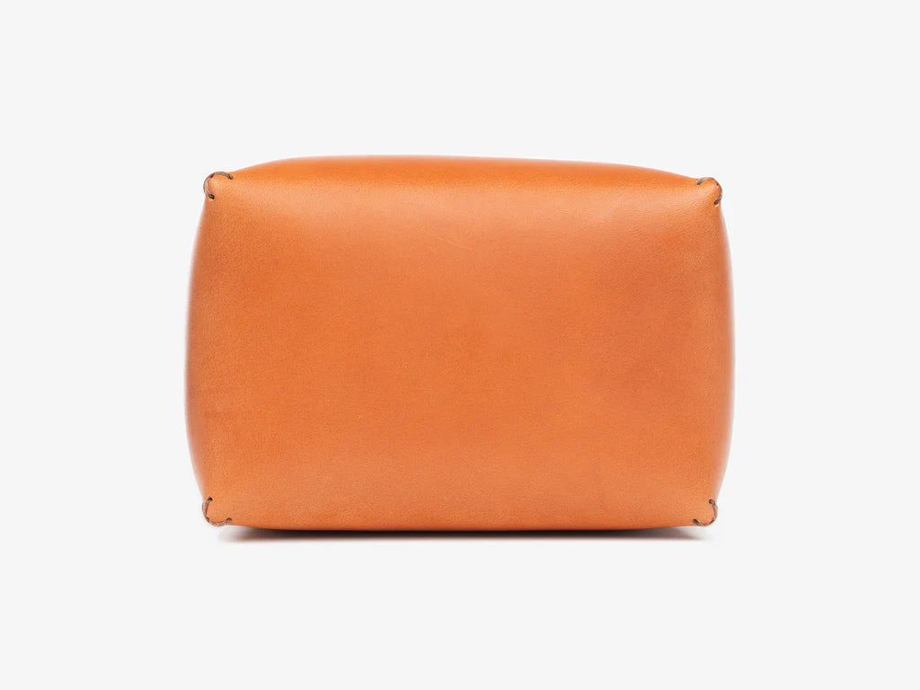 Top view of a tan leather box lid showing where the debossed personalization gets stamped. Set against a white background.