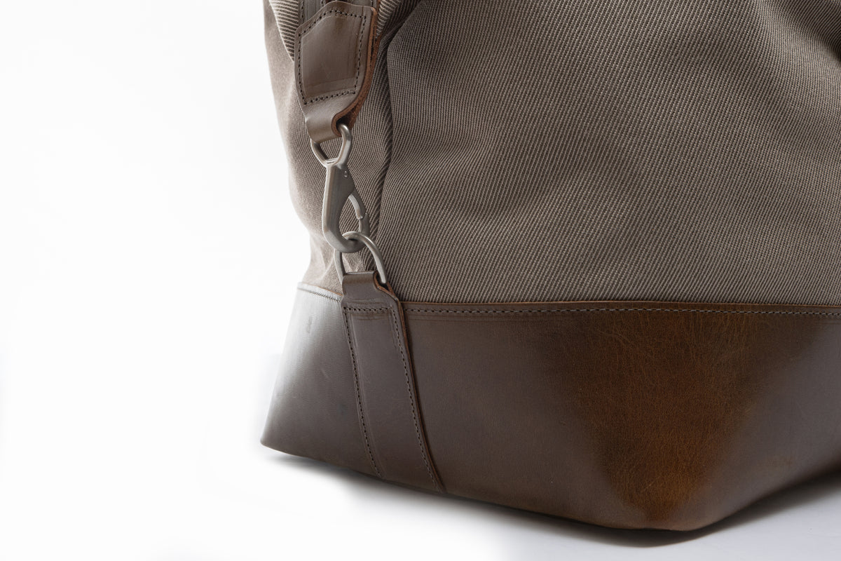 Close-up of a olive leather bag with a white background