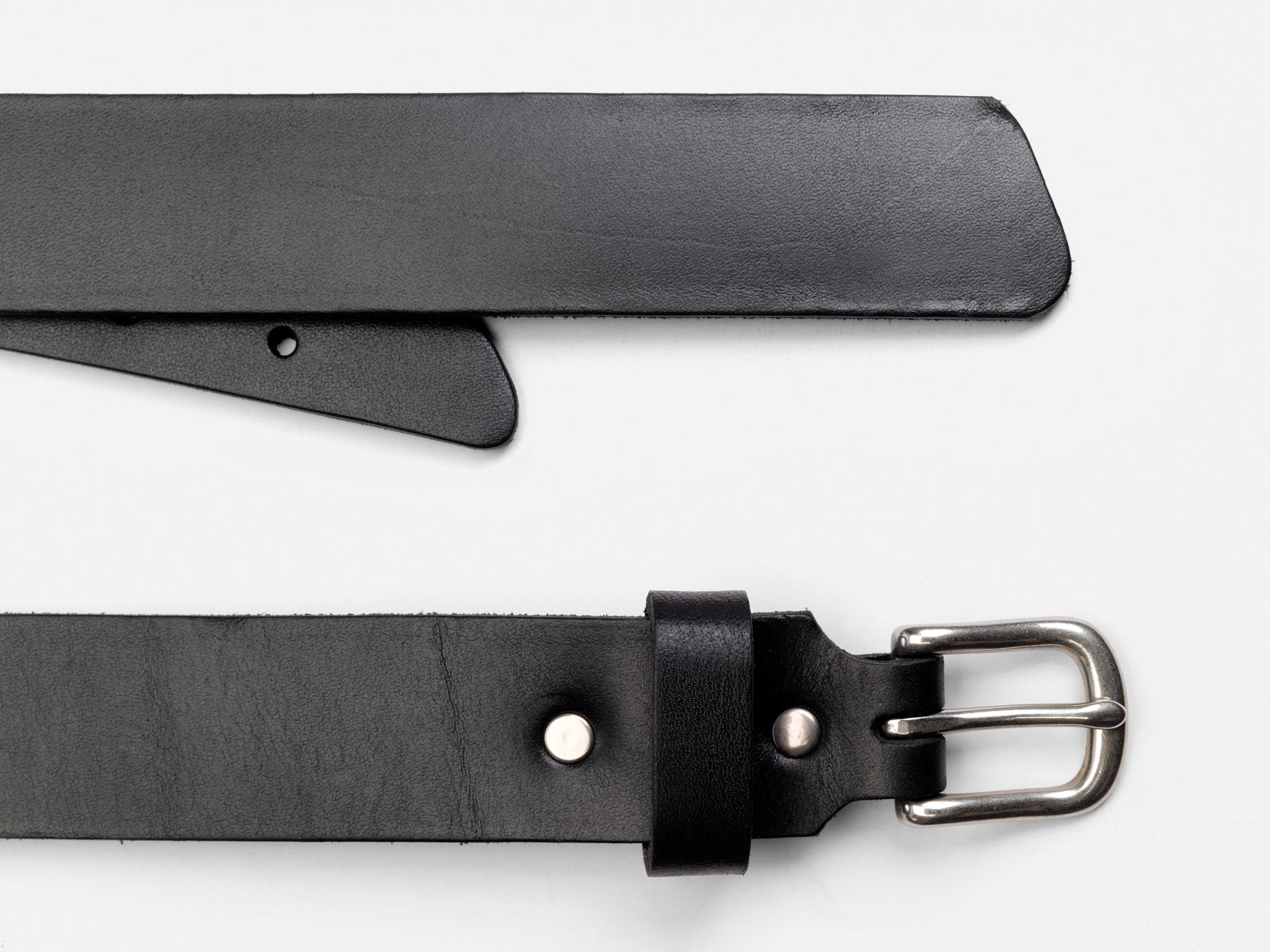 A close-up of a black leather belt with a silver buckle shown against a white background. The belt is laid flat, with the buckle end at the bottom and the pointed end at the top.