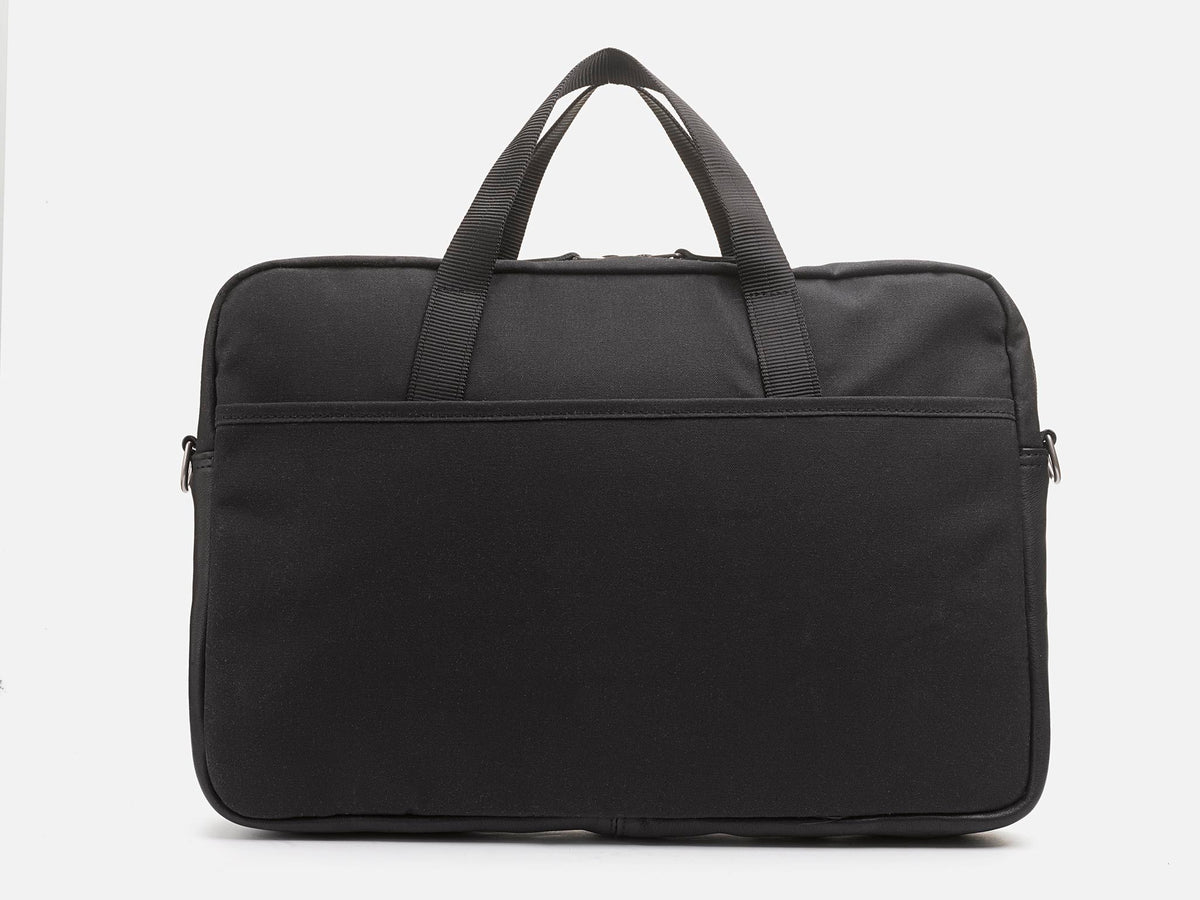 A black laptop bag with two short handles, a front pocket, and a simple, minimalist design, shown against a white background.