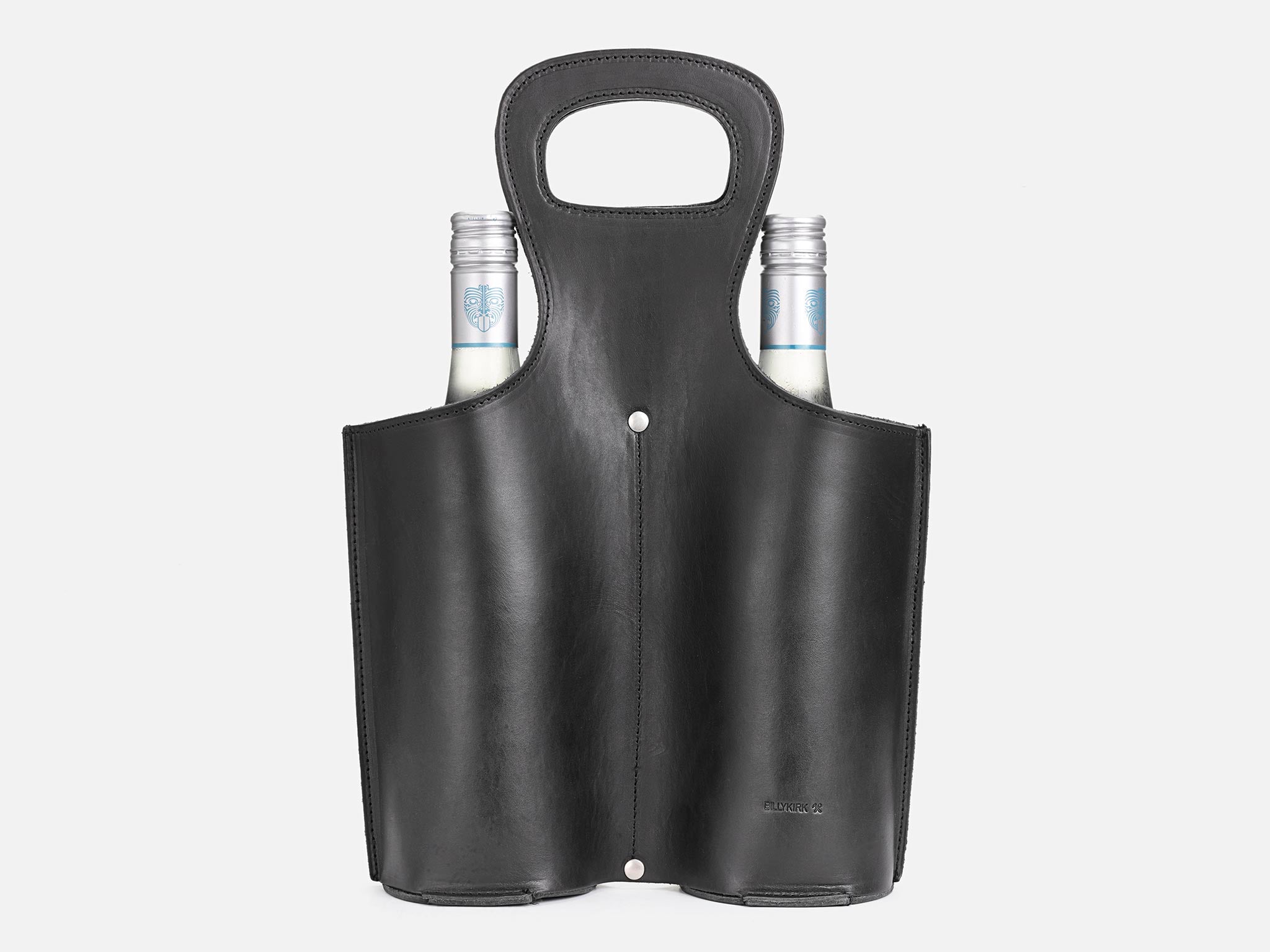A black leather wine tote holds two bottles with silver caps, partially visible, against a white background. The tote has a built-in handle and a sleek, minimalist design.