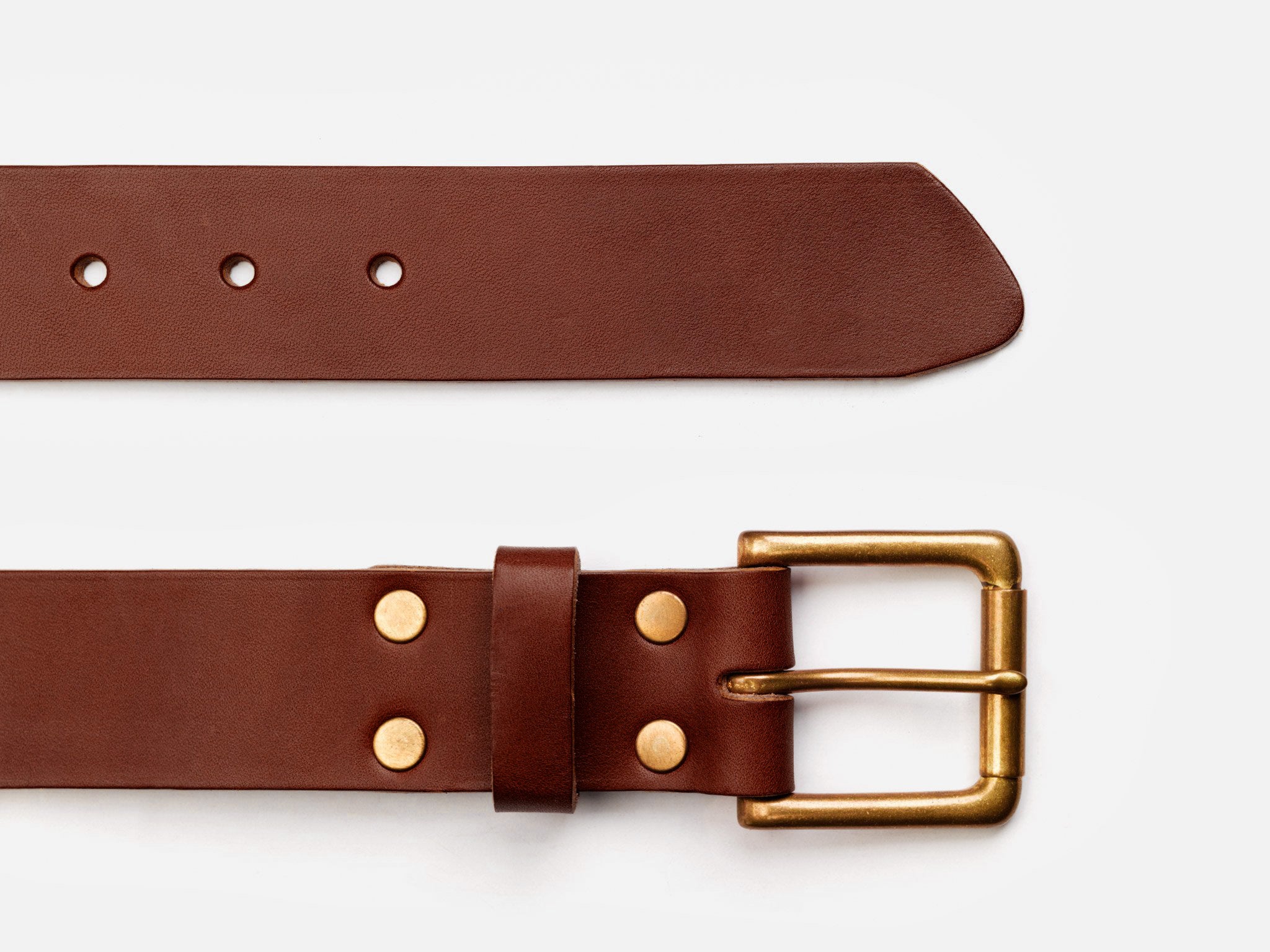 A brown leather belt with a gold-colored metal buckle and rivets, shown laid flat on a white background. The belt has several adjustment holes visible.