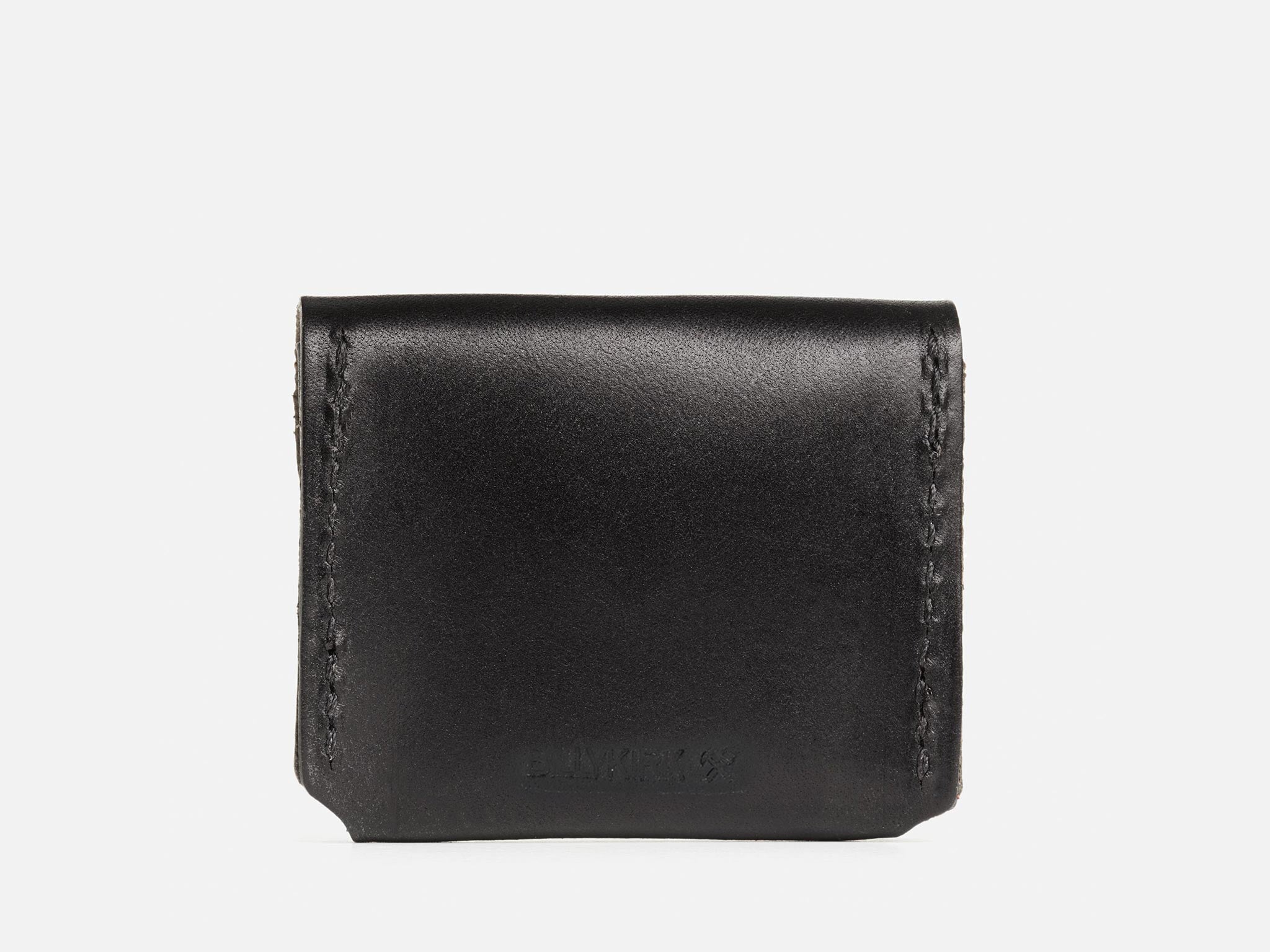 The back of a black coin pouch with hand-stitched edges with a Billykirk logo embossed at the bottom