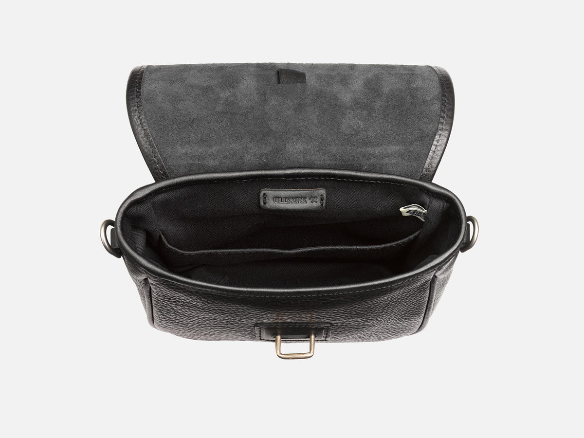 Open black leather crossbody bag with a fabric-lined interior, showing multiple compartments and a zippered pocket inside. The lid is flipped back, revealing the textured leather exterior and suede interior flap.