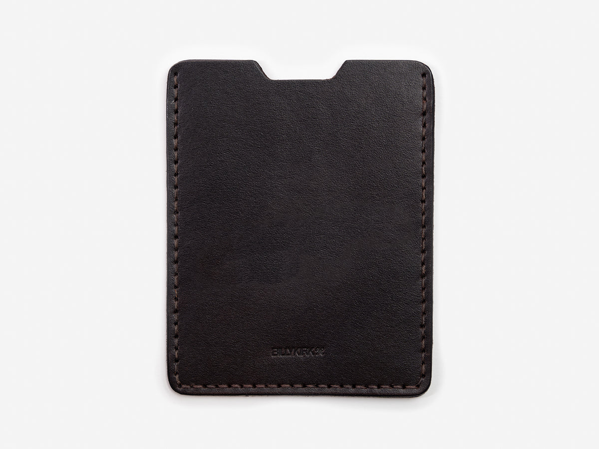A minimalist, black leather card holder with visible stitching around the edges, displayed against a plain white background.