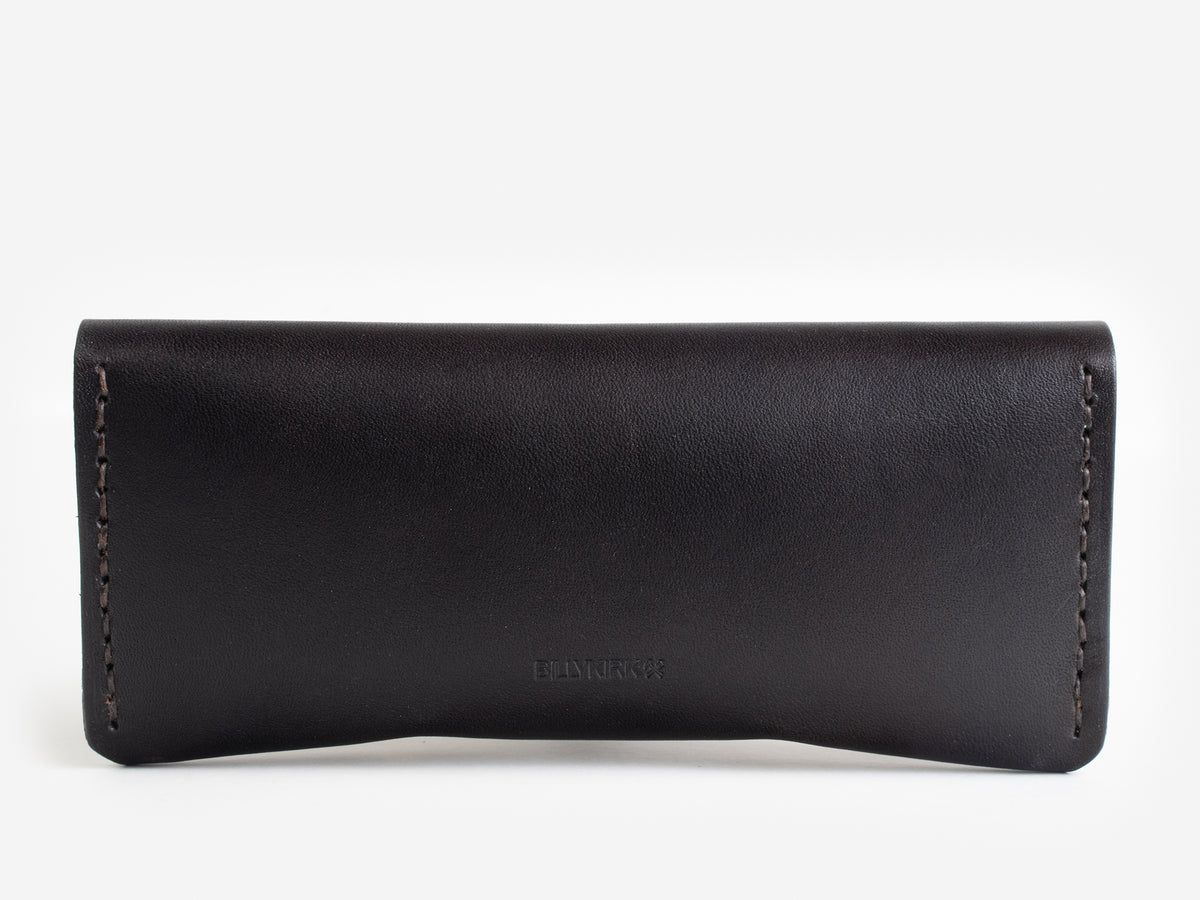 A minimalist, rectangular black leather case with visible stitching along the sides, photographed against a white background.