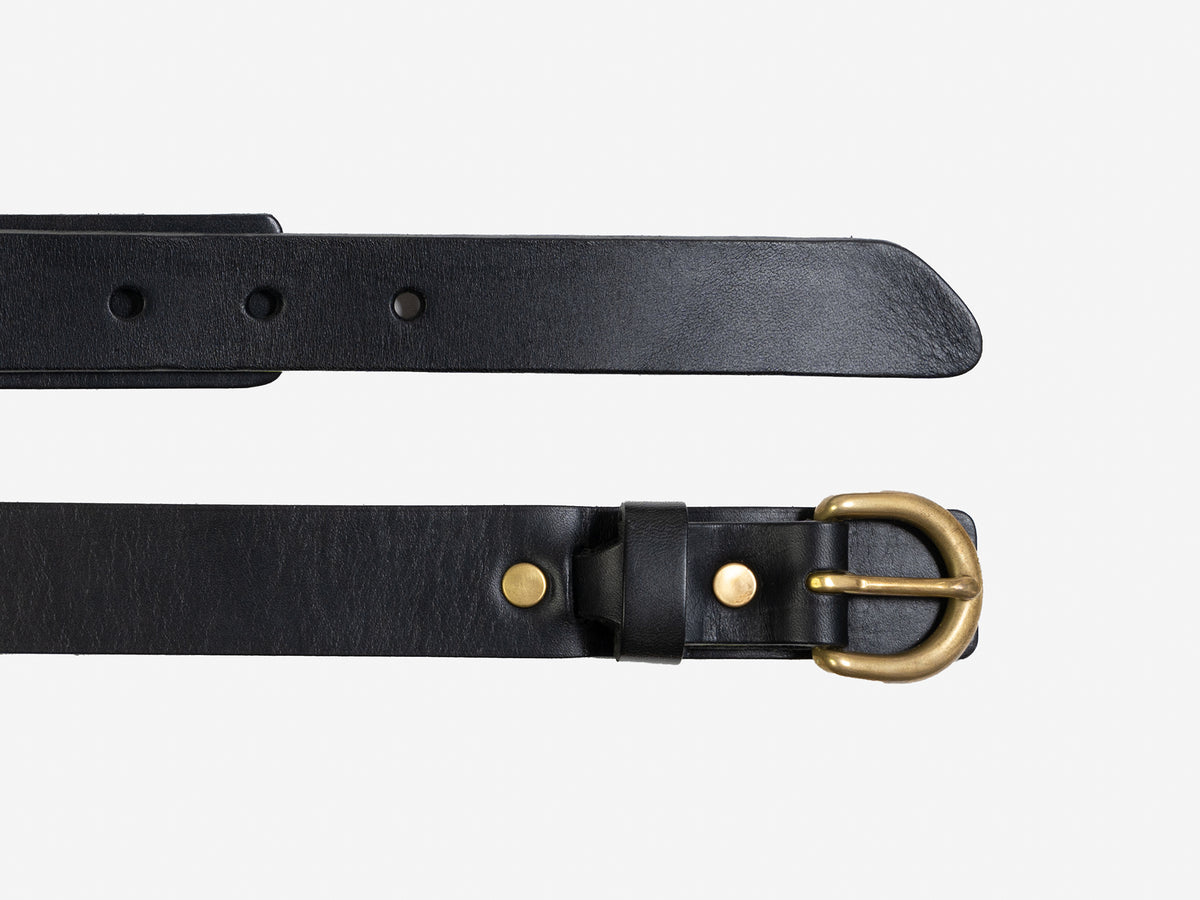 A black leather belt with a gold-colored metal buckle and brass rivets, displayed laid flat on a white background. The belt has multiple adjustment holes.