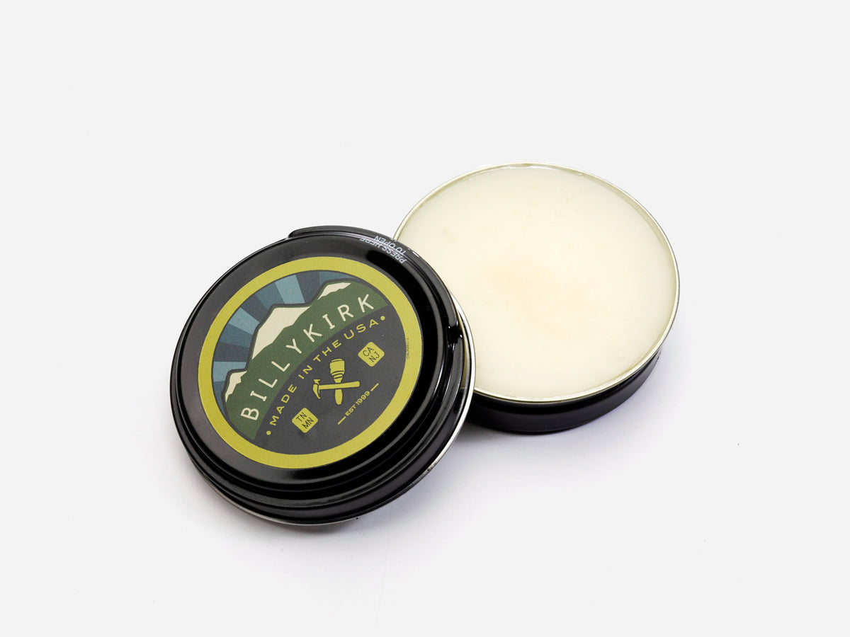 Open tin jar of canvas refinishing wax with Billykirk logo