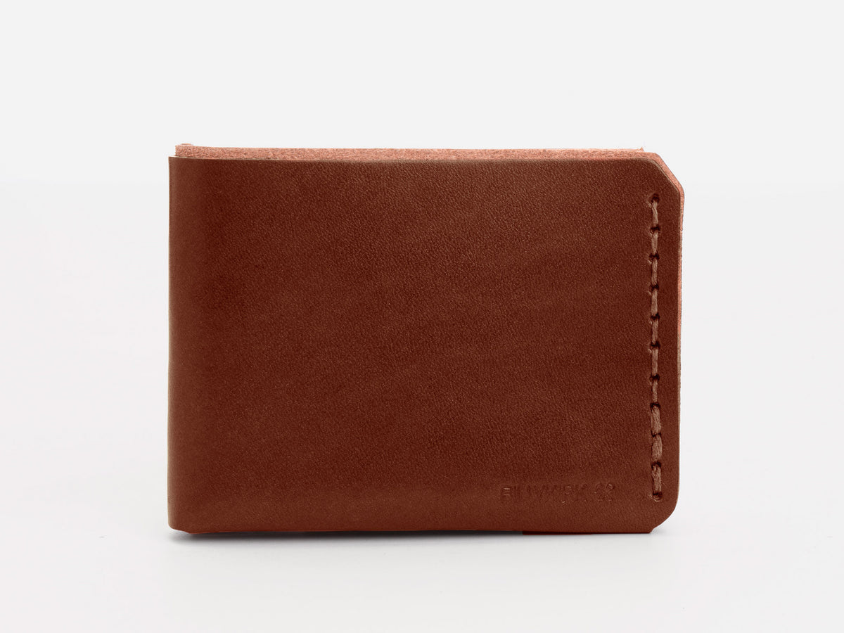 A brown leather bifold wallet with visible stitching along the right edge, displayed closed against a plain white background.